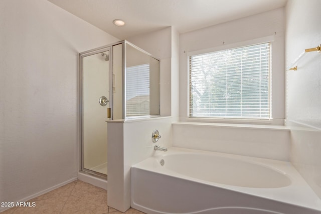 bathroom with tile patterned flooring and separate shower and tub