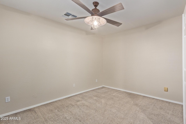 carpeted spare room with ceiling fan