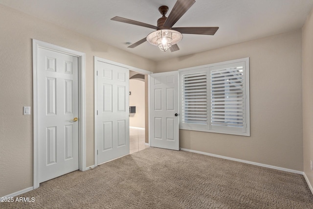 unfurnished bedroom featuring carpet flooring and ceiling fan