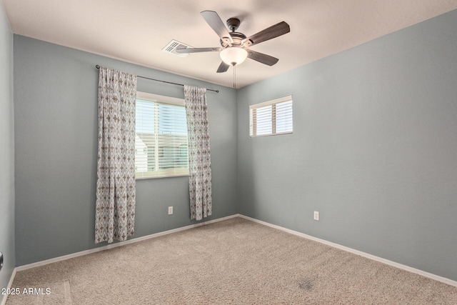 empty room featuring carpet flooring and ceiling fan