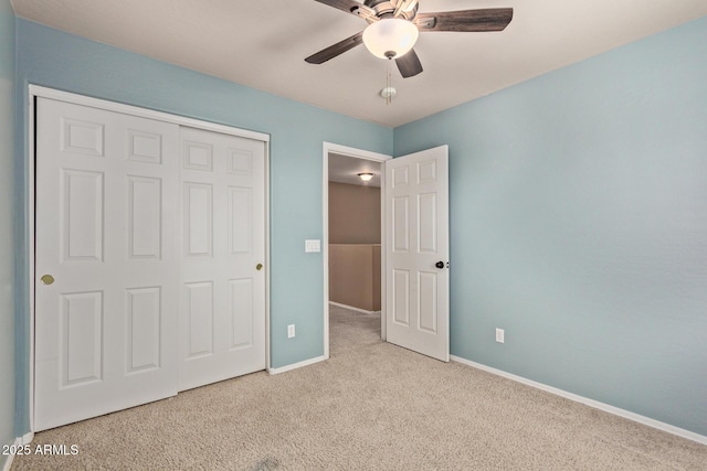 unfurnished bedroom with light carpet, a closet, and ceiling fan