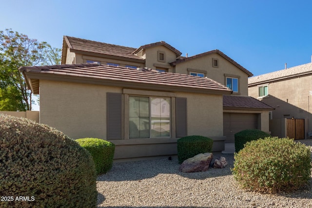 rear view of house featuring a garage