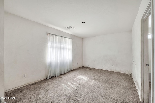 spare room featuring carpet and visible vents