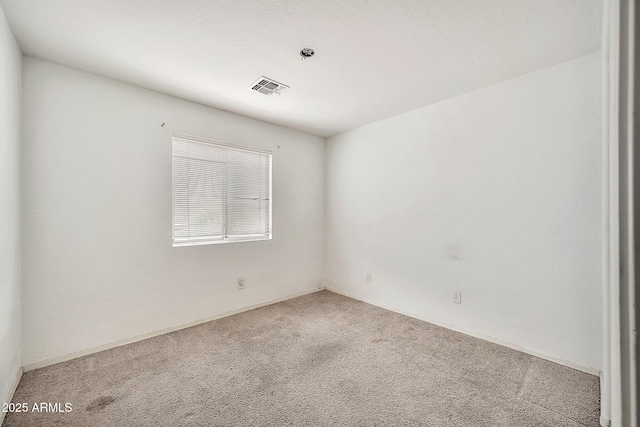 spare room with carpet floors and visible vents