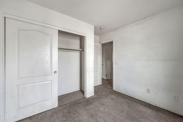 unfurnished bedroom featuring a closet and carpet