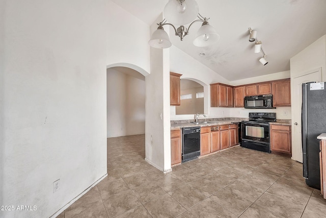 kitchen featuring arched walkways, lofted ceiling, light countertops, black appliances, and a sink