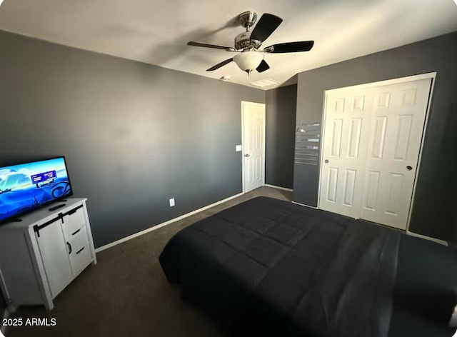 bedroom with a closet, dark carpet, and ceiling fan