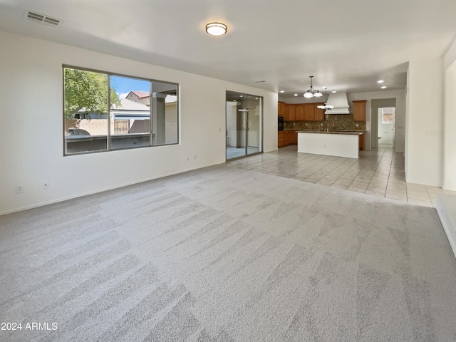 unfurnished living room with light carpet