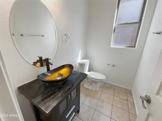 bathroom with vanity, tile patterned flooring, and toilet