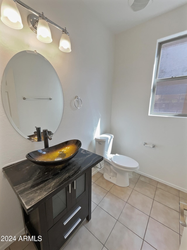 bathroom featuring vanity, tile patterned flooring, and toilet