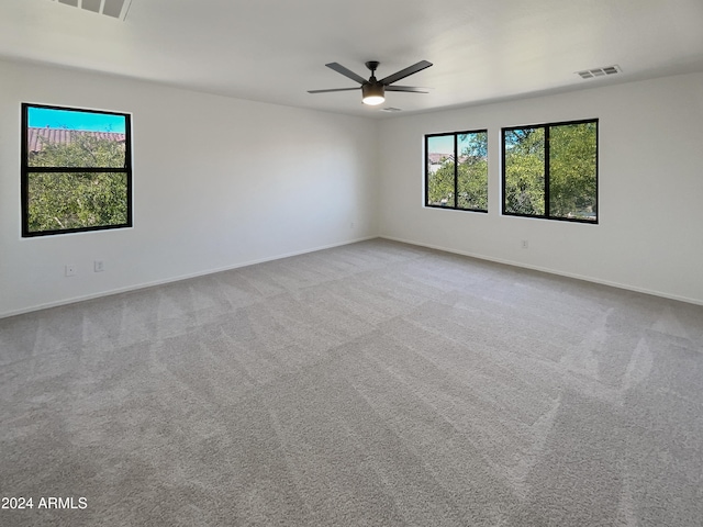 empty room with ceiling fan and carpet flooring