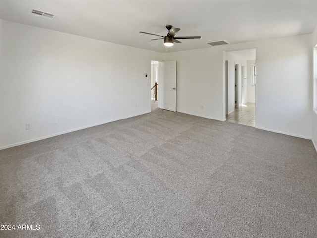 empty room with ceiling fan and light colored carpet