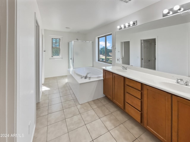 bathroom with independent shower and bath, vanity, and tile patterned flooring