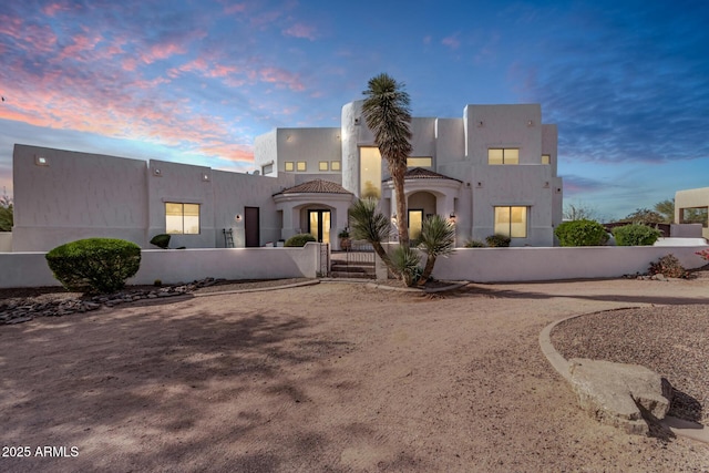 view of front of property featuring a fenced front yard and stucco siding