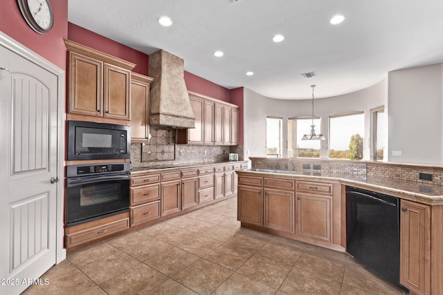 kitchen with pendant lighting, custom exhaust hood, sink, black appliances, and decorative backsplash