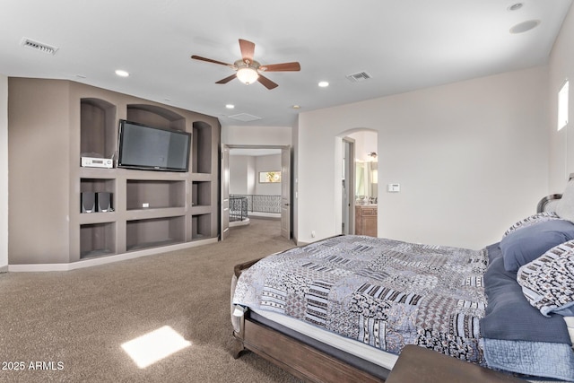 carpeted bedroom with ceiling fan and ensuite bathroom