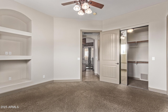 unfurnished bedroom featuring a closet, ceiling fan, and dark colored carpet