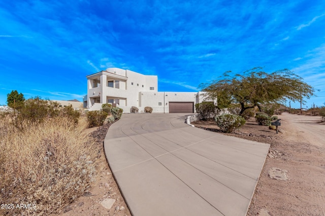 pueblo-style home featuring a garage