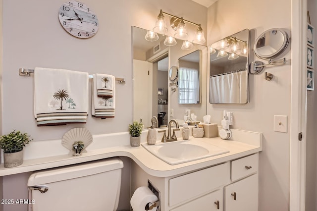 full bath featuring toilet, visible vents, and vanity