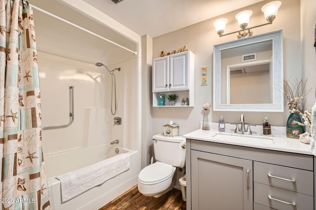 bathroom with visible vents, shower / bath combo with shower curtain, toilet, wood finished floors, and vanity