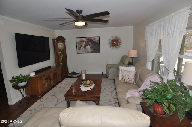living room featuring wood finished floors, baseboards, ceiling fan, and crown molding
