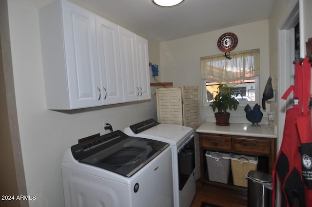 washroom featuring independent washer and dryer, cabinet space, and wood finished floors