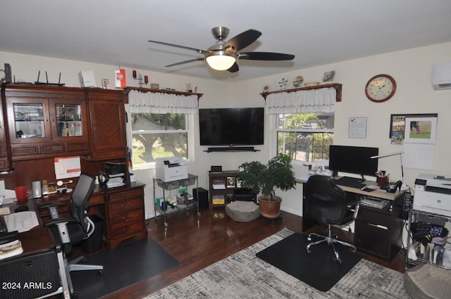 office area featuring a ceiling fan, wood finished floors, and an AC wall unit