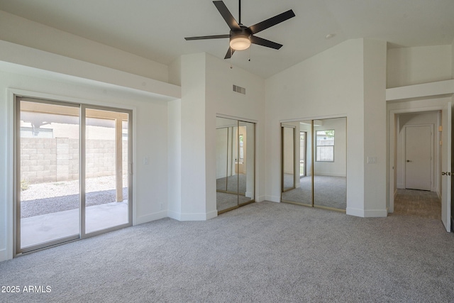 4248 E Jason Dr, Phoenix, AZ 85050 - unfurnished bedroom with carpet floors, access to outside, two closets, baseboards, and high vaulted ceiling
