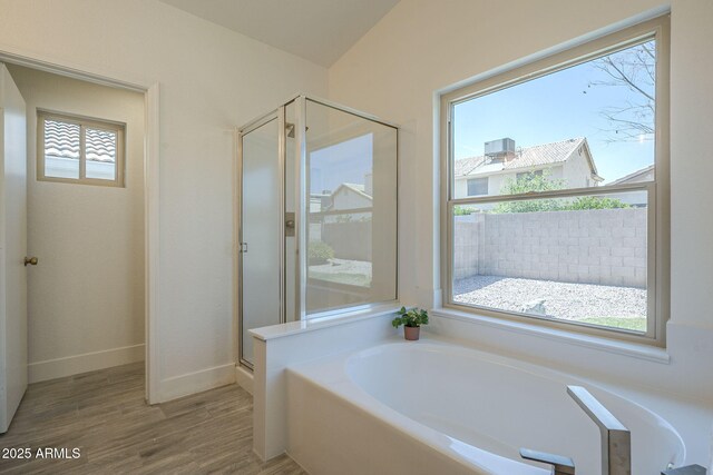 4248 E Jason Dr, Phoenix, AZ 85050 - bathroom with a bath, a shower stall, wood finished floors, and baseboards