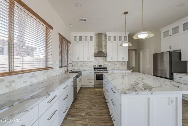 1826 W Oriole Way, Chandler, AZ 85286 - kitchen featuring stainless steel appliances, wall chimney exhaust hood, a kitchen island, tasteful backsplash, and dark wood-style floors