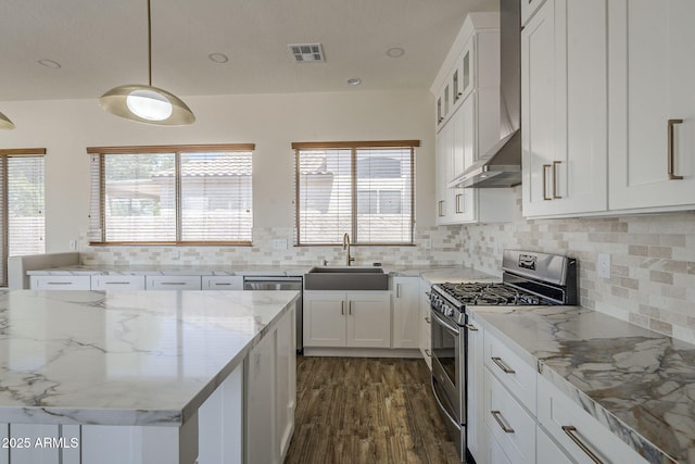 1826 W Oriole Way, Chandler, AZ 85286 - kitchen featuring appliances with stainless steel finishes, wall chimney exhaust hood, white cabinetry, and plenty of natural light