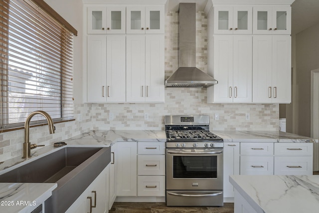 1826 W Oriole Way, Chandler, AZ 85286 - kitchen with stainless steel gas stove, wall chimney exhaust hood, decorative backsplash, white cabinetry, and light stone counters