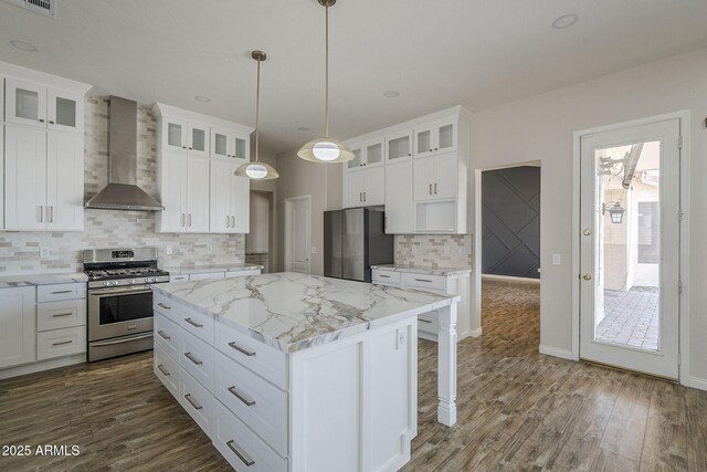 1826 W Oriole Way, Chandler, AZ 85286 - kitchen with stainless steel appliances, wall chimney exhaust hood, a center island, tasteful backsplash, and dark wood-style floors
