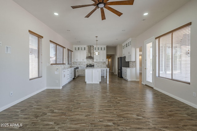 1826 W Oriole Way, Chandler, AZ 85286 - kitchen featuring freestanding refrigerator, wall chimney range hood, a ceiling fan, backsplash, and dark wood finished floors