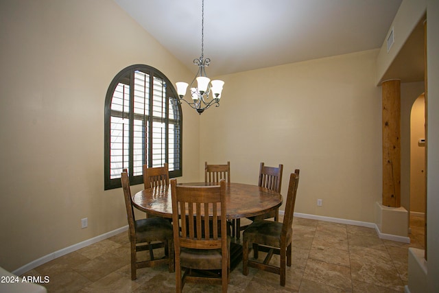 dining space featuring lofted ceiling and a notable chandelier