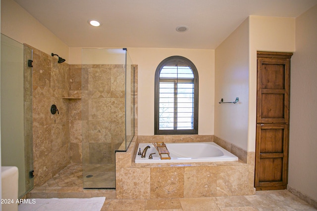 bathroom with shower with separate bathtub