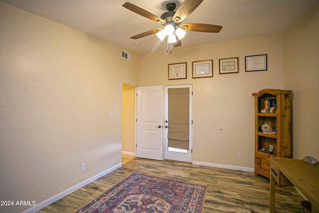 interior space with wood-type flooring and ceiling fan