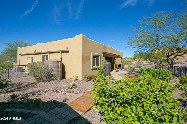 back of property featuring cooling unit and a patio