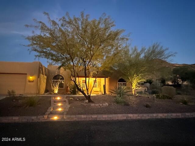 pueblo-style house featuring a garage