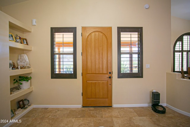 entryway featuring vaulted ceiling