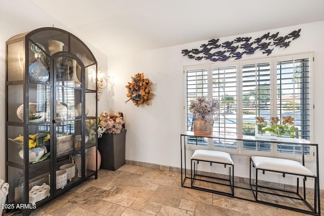 dining space featuring stone tile flooring and baseboards