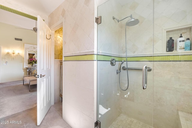 bathroom with a stall shower, tile patterned flooring, and visible vents