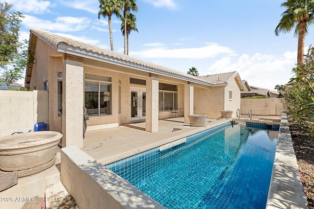 view of pool with a fenced backyard, a fenced in pool, a patio, and french doors