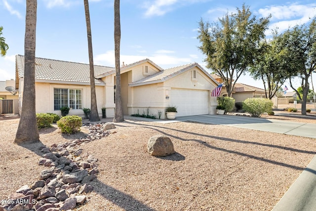 view of front of house featuring a tile roof, stucco siding, an attached garage, cooling unit, and driveway