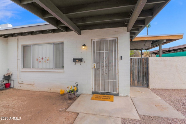 doorway to property featuring fence