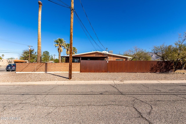 view of home's exterior with fence