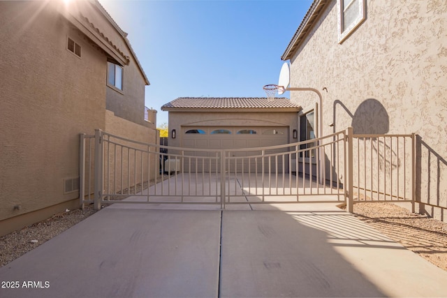 view of gate with a garage