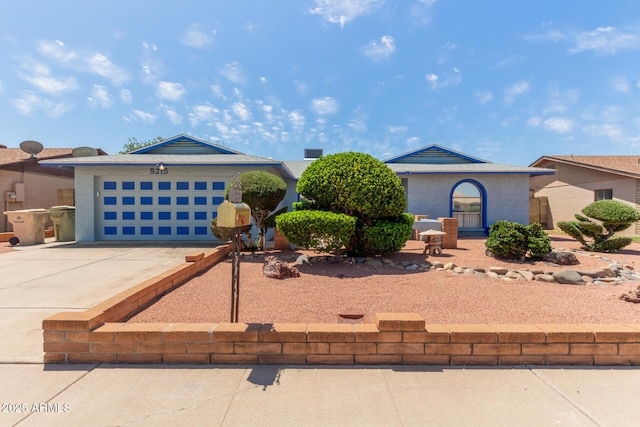 view of front of home featuring concrete driveway and a garage