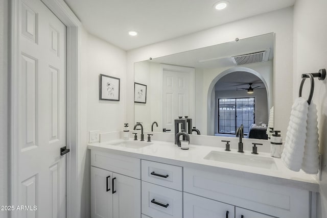 bathroom with ceiling fan and vanity