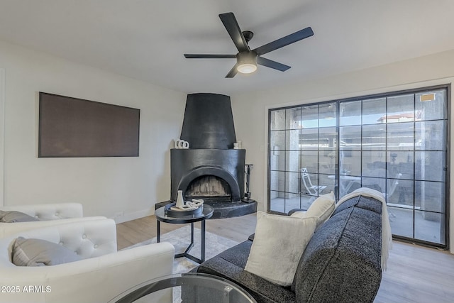 living room featuring light hardwood / wood-style flooring and ceiling fan